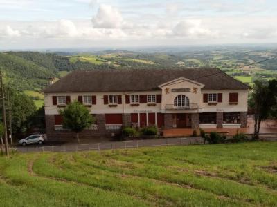 a large house on top of a green field at La Maison d'Osquich in Musculdy