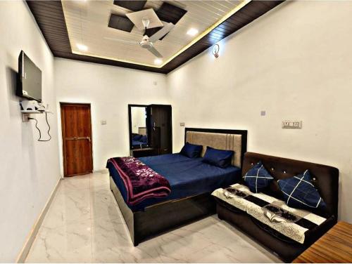 a bedroom with a bed and a couch at SK Palace in Rāe Bareli