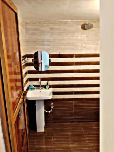 a bathroom with a sink and a shower at SK Palace in Rāe Bareli