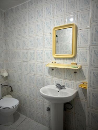 a bathroom with a sink and a mirror on the wall at Catalan in Martil