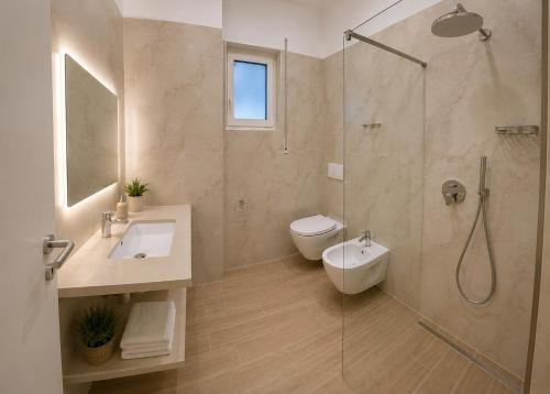 a bathroom with a shower and a toilet and a sink at Flors Apartments in Durrës
