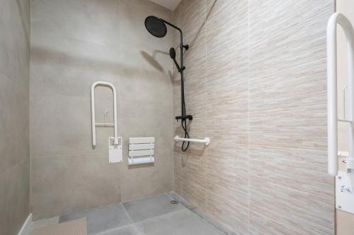 a bathroom with a shower with a glass door at Sanchis Studios in Alicante