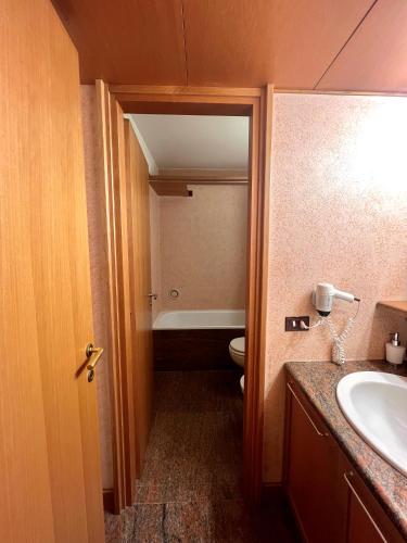 a bathroom with a toilet and a sink at Monolocale Des Alpes 204 in Madonna di Campiglio