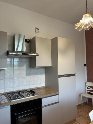 a kitchen with a stove and a refrigerator at Casa Ciccone-L'Aquila in Tornimparte
