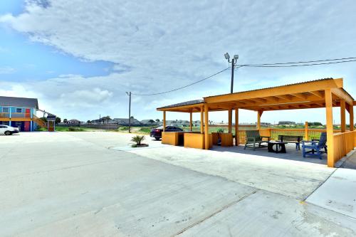 a pavilion with a picnic table and a bench at Monterrey Motel Padre Island, Corpus Christi BY OYO in Padre Island