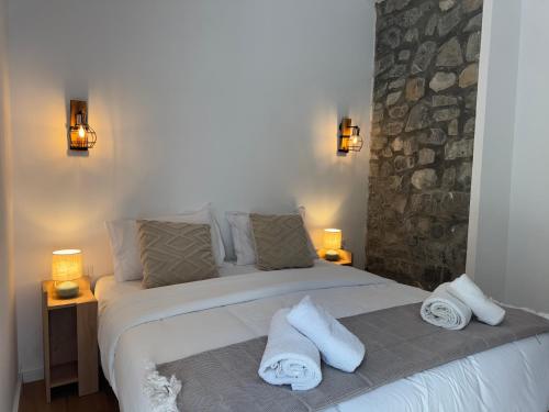 a bedroom with a bed with towels on it at Hotel Vellezrit Guri in Theth