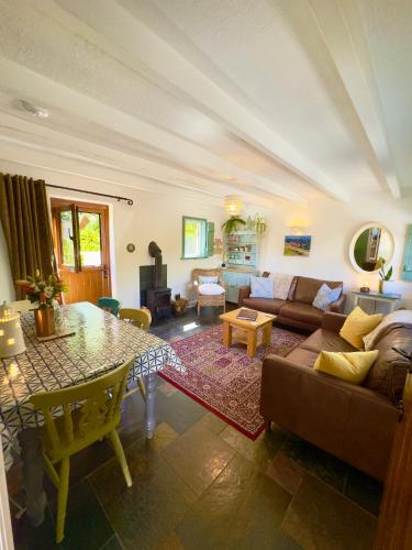 a living room with a couch and a table at Vale View Cottages -The Coach House, Great location in Prestatyn! in Prestatyn