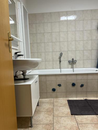 a bathroom with a sink and a bath tub at Little Rostock in Papendorf