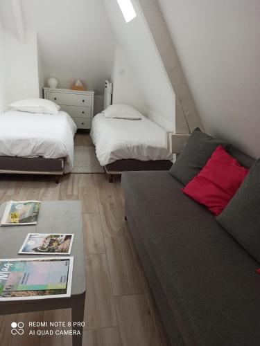 a living room with two beds and a couch at Ramier in Giverny
