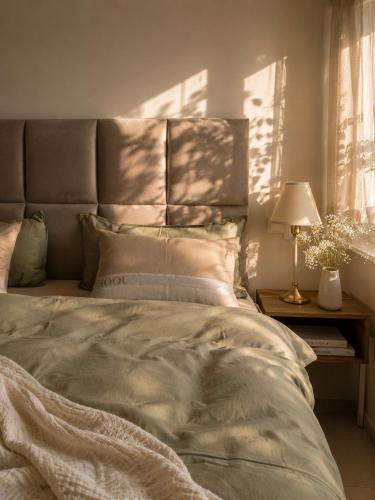 a bedroom with a bed with a headboard and a lamp at Erftlodges L1 in Bad Münstereifel