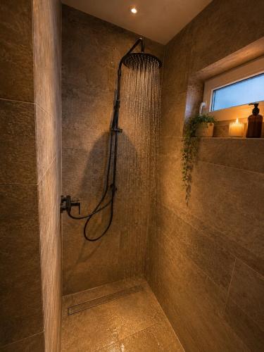 a bathroom with a shower with a shower curtain at Erftlodges L1 in Bad Münstereifel