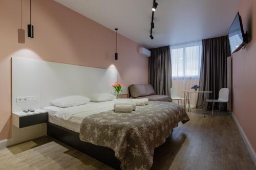 a bedroom with a large bed in a room at Вікторі Апарт in Kyiv