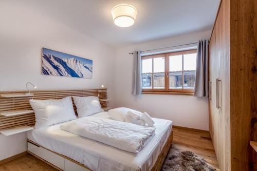 Postel nebo postele na pokoji v ubytování Alpin Residenzen Panoramabahn by Alpina-Holiday