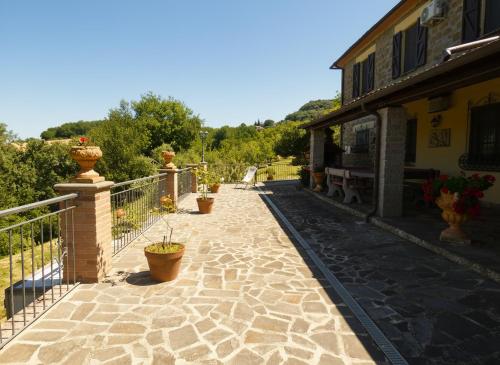 a walkway with potted plants on a building at Scappo in Umbria, L'antico casale in Narni