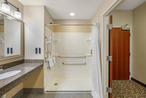 a bathroom with a shower and a sink at Best Western PLUS Fossil Country Inn & Suites in Kemmerer