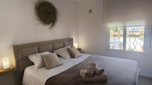 a bedroom with a bed with two towels on it at Casa Marie - Albir in Albir