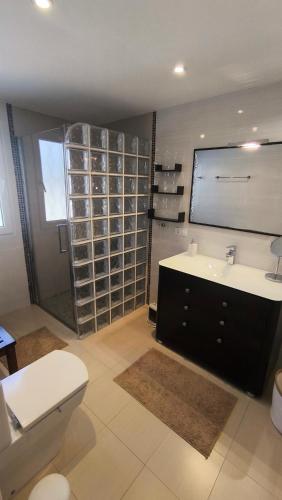 a bathroom with a toilet and a sink and a shower at Casa Marie - Albir in Albir
