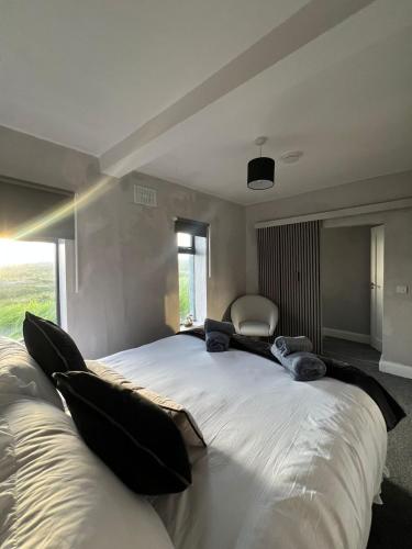 a large white bed in a room with a window at Sea breeze house in Dog Island