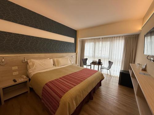 a hotel room with a bed and a table and chairs at Regente Palace Hotel in Buenos Aires