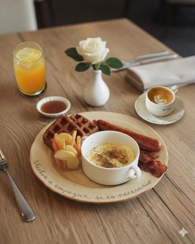 a plate of breakfast food with toast and a cup of coffee at Veca Flats Centenario in Cali