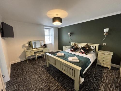 a bedroom with a bed and a mirror at Abbotshall in Fife