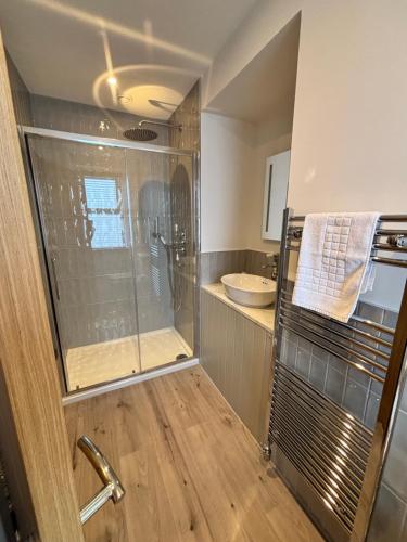 a bathroom with a shower and a sink at Abbotshall in Fife