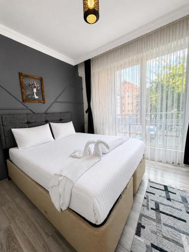 a bedroom with a large bed with white sheets at Bolu novara suit in Bolu