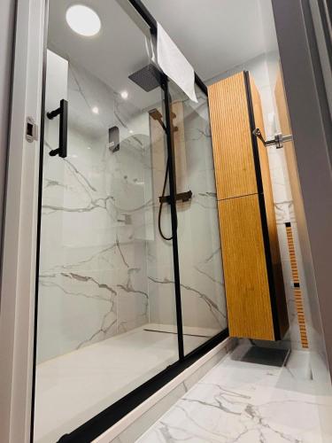 a shower with a glass door in a bathroom at CriteriaHome! nice&easy in Madrid