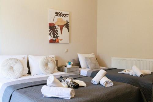 a bedroom with two beds with towels on them at Studios Denis in Stavros