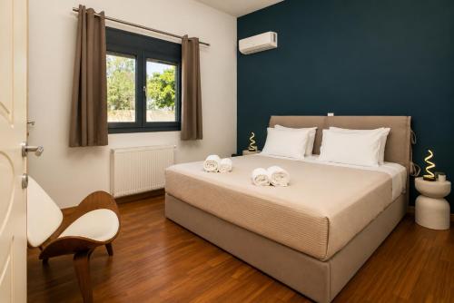 a bedroom with a bed with two towels on it at AVENTINE - Luxury Residences with Private Pools in Kalithies