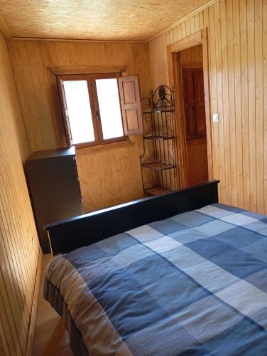 a bedroom with a bed in a room with a window at Cabaña Cala Blanca II in Málaga