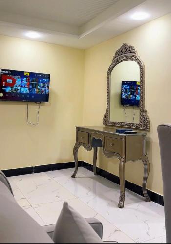 a dressing table and a mirror in a room at Seven Sky Hotel in Murree