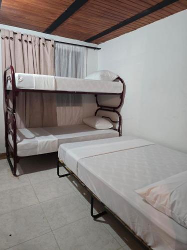 two bunk beds sitting in a room with at Finca la santa in San Luis de Cubarral