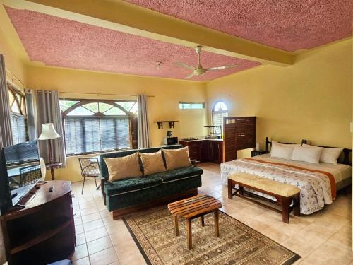 a living room with a bed and a couch at Kariba Kariba in Mandeville