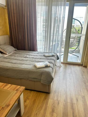 a bedroom with a bed and a large window at Dream 3 in Sunny Beach