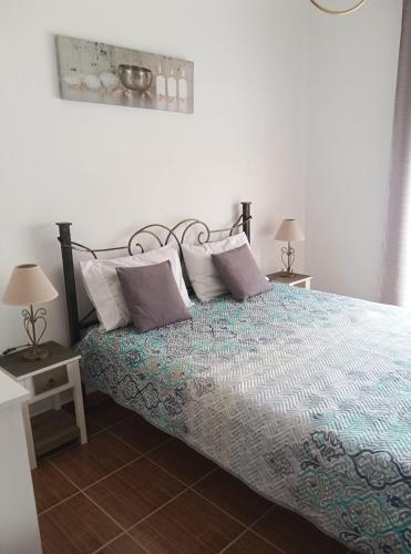 a bedroom with a bed with pillows on it at Casa Afonso Guesthouse in Ferrel
