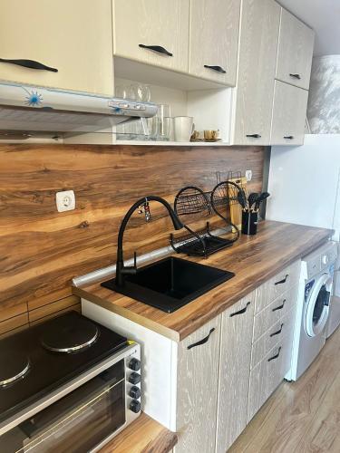a kitchen with a sink and a stove at Dream 3 in Sunny Beach