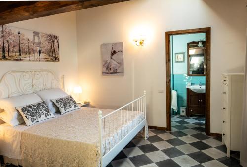 a bedroom with a bed and a bathroom with a mirror at La casa di Mariasole in SantʼElpidio a Mare