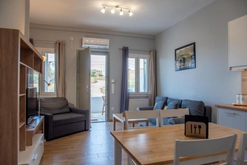 a living room with a couch and a table at Easy Living Tinos in Vrachonisída Chántra