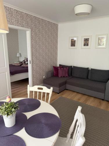 a living room with a couch and a table at Šaulys in Druskininkai