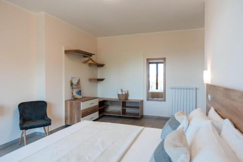 a bedroom with a bed and a desk and a chair at La Rocca di PA in Tropea