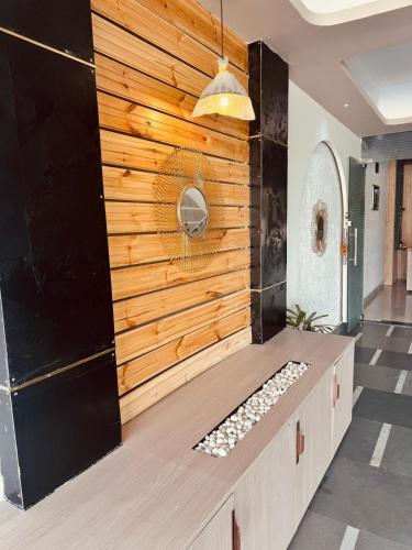 a room with a wooden wall with a bench in it at Satya Avenue Dehradun, Near Pearl Paradise IT park Road in Dehradun