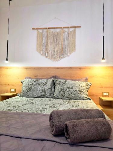 a bedroom with a large bed with two pillows at Anthouli Homes 2, steps from beach and centre in Kardamaina