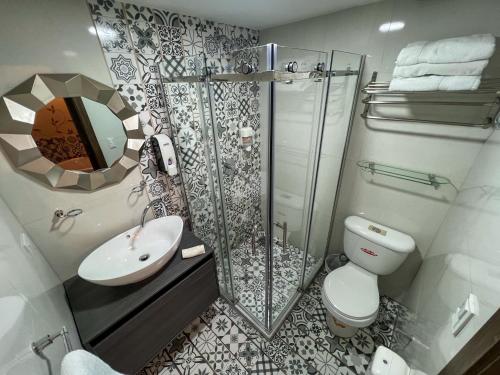 a bathroom with a shower and a toilet and a sink at Ronda Hotel Boutique by Chat Noir in Cuenca