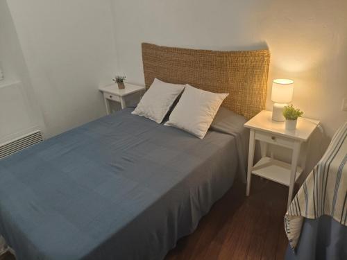 a bedroom with a blue bed with two night stands at Casa Rivendell in Ladrido