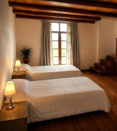 a bedroom with a large bed and a window at Loft Casa Yucay in Yucay