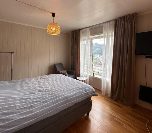 a bedroom with a bed and a chair and a window at Otta Studio apartment in Sel