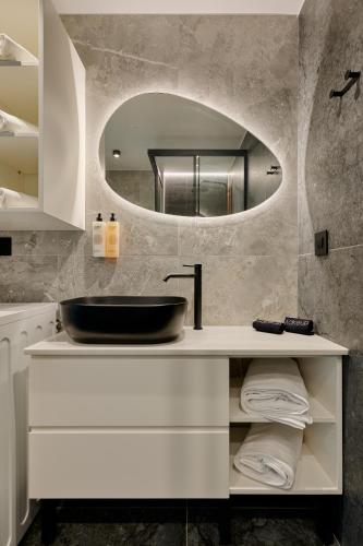 a bathroom with a sink and a mirror at Agia Triada Suites in Heraklio