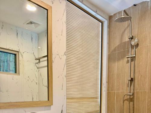 a bathroom with a shower and a mirror at Phi Phi Vista Nest Resort in Phi Phi Islands