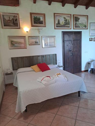 a bedroom with a bed with two towels on it at Vista Lago B&B in Gavirate